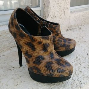 Pair of snake skin womens ankle booties